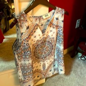 Beautiful multi color sleeveless shirt. Never worn